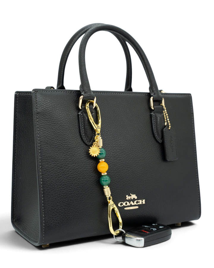 LD Keyfinder Golden Harvest-Mini beaded keychain with green and orange agate beads and a gold sunflower charm on a bag