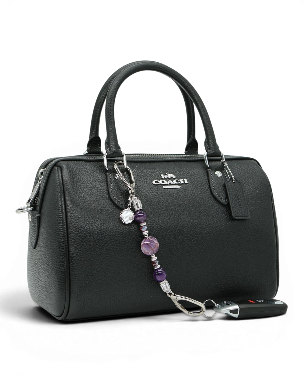 LD Keyfinder Petite Amethyst Moon keychain with genuine amethyst beads, artisan glass, and moon charm on a black handbag.
