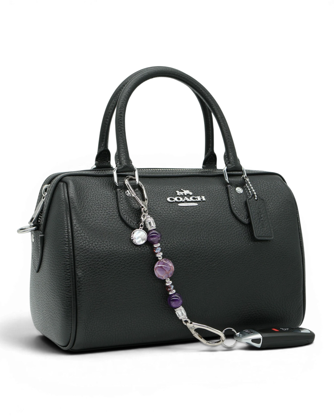 LD Keyfinder Petite Amethyst Moon keychain with genuine amethyst beads, artisan glass, and moon charm on a black handbag.
