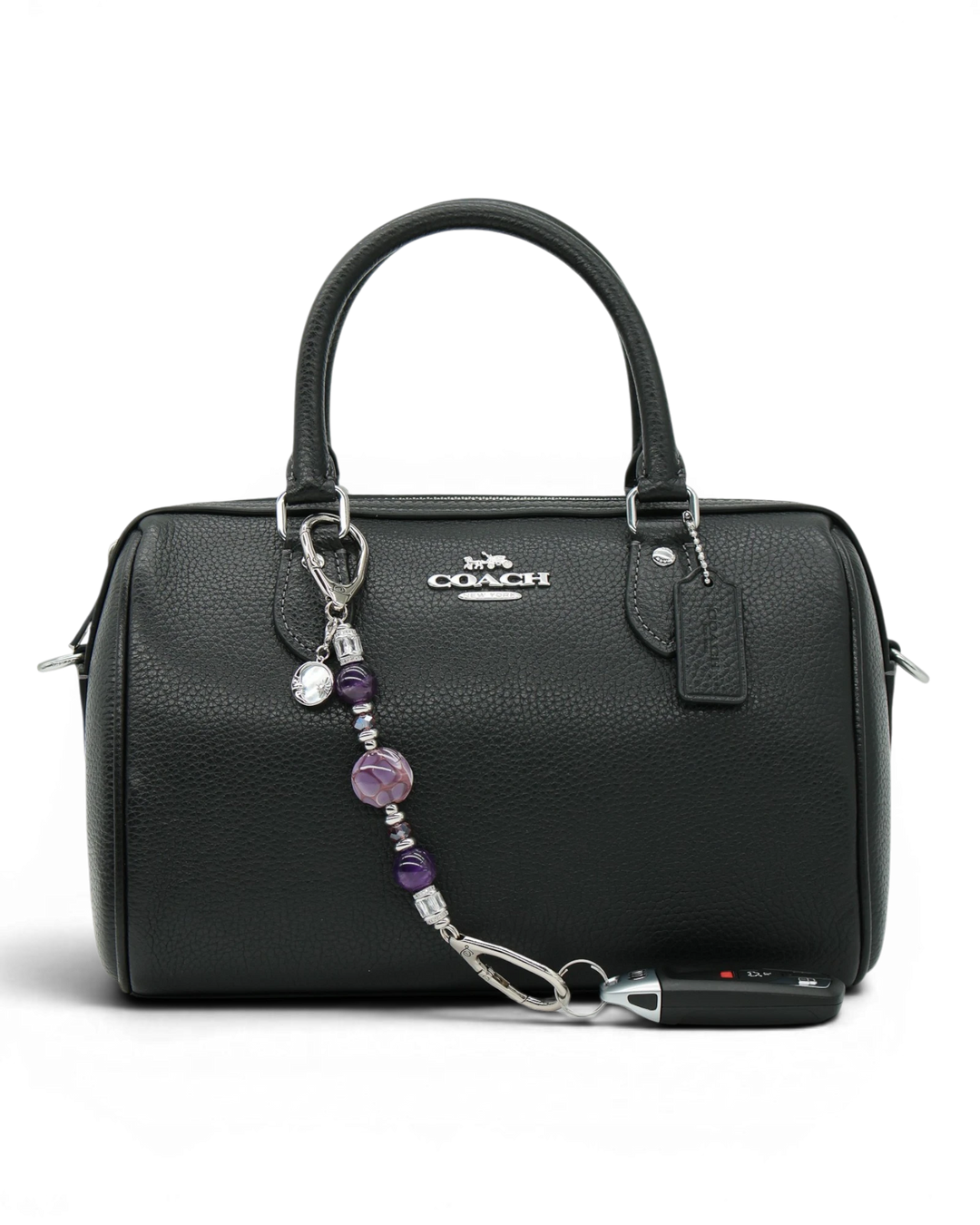 LD Keyfinder Petite Amethyst Moon charm with purple beads, rhinestones, and moon charm on a black handbag.
