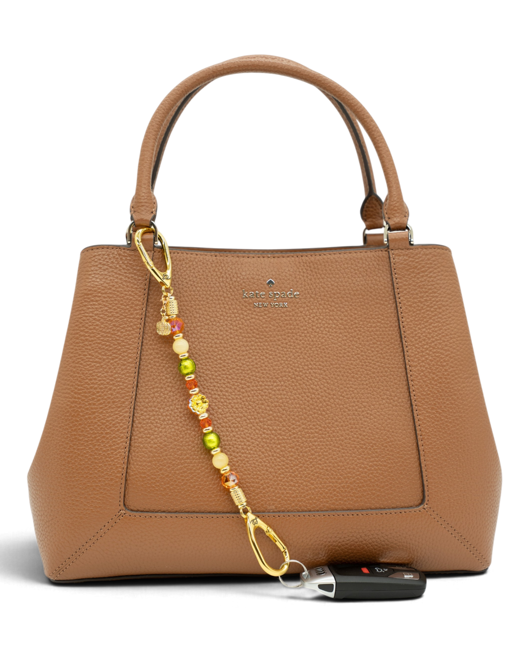 LD Keyfinder Autumn Festival beaded accessory with flower and pumpkin charms attached to a brown leather handbag.