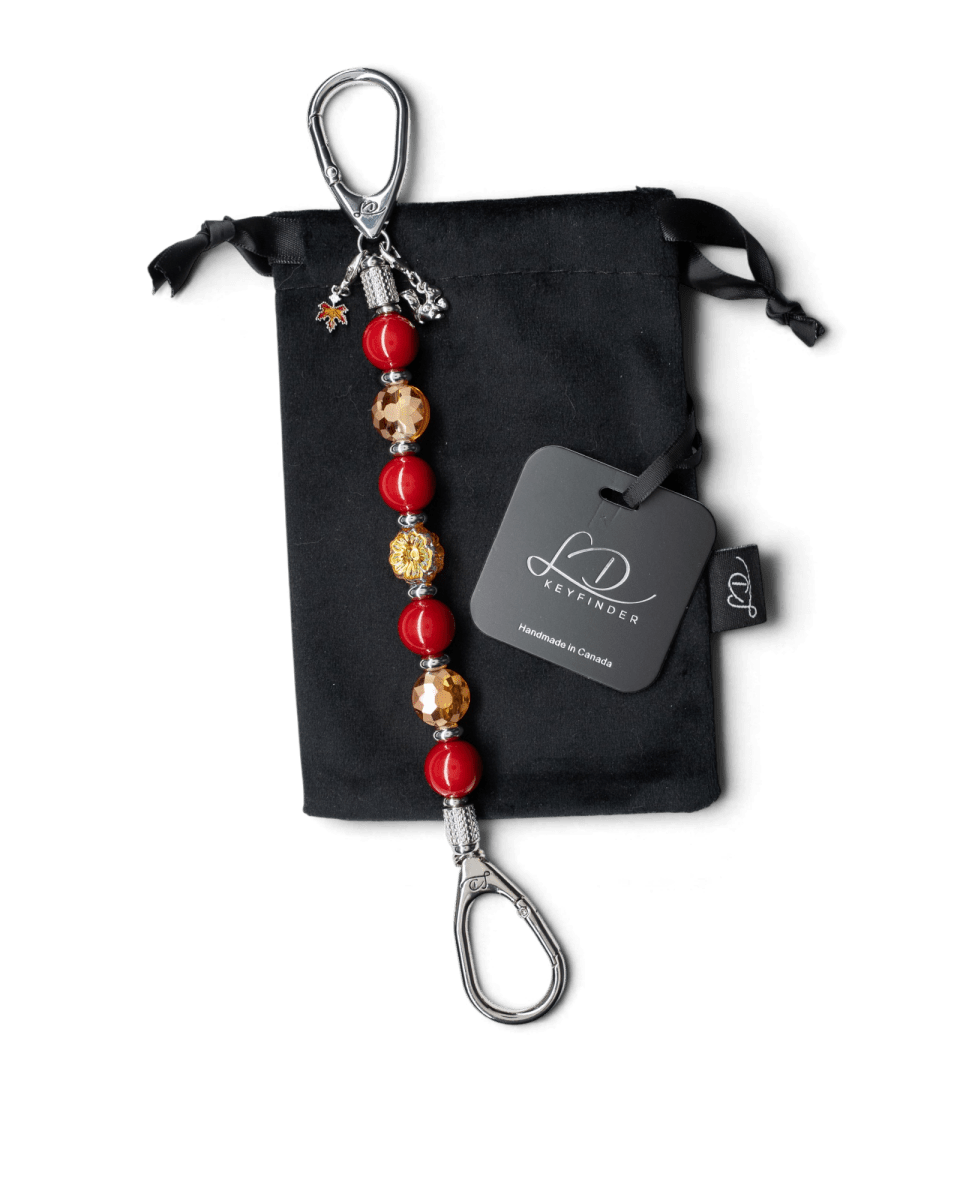 LD Keyfinder Autumn Whispers beaded keychain with red shell pearls, orange glass flower, and squirrel and leaf charms.