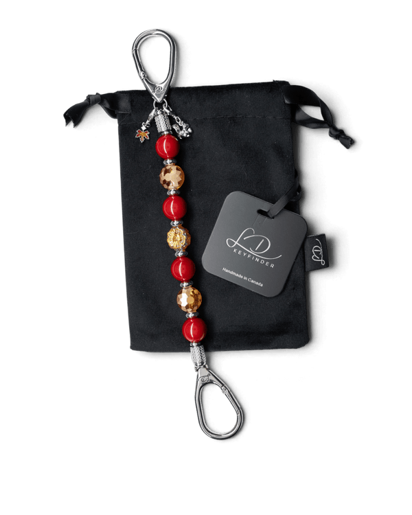 LD Keyfinder Autumn Whispers beaded keychain with red shell pearls, orange glass flower, and squirrel and leaf charms.