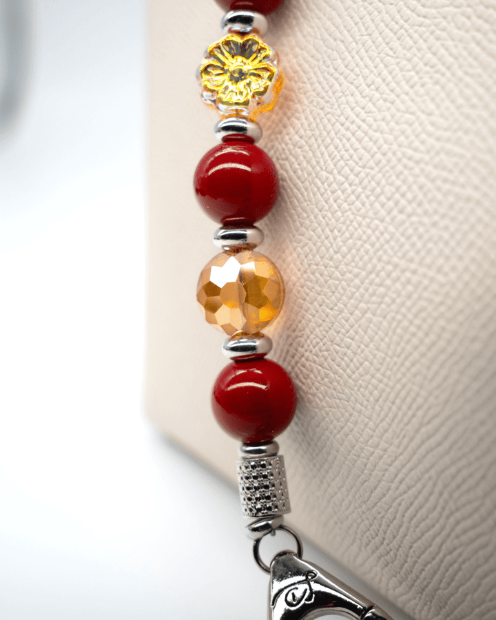 LD Keyfinder Autumn Whispers beaded keychain with red shell pearls, orange glass flower, and platinum-plated accents.