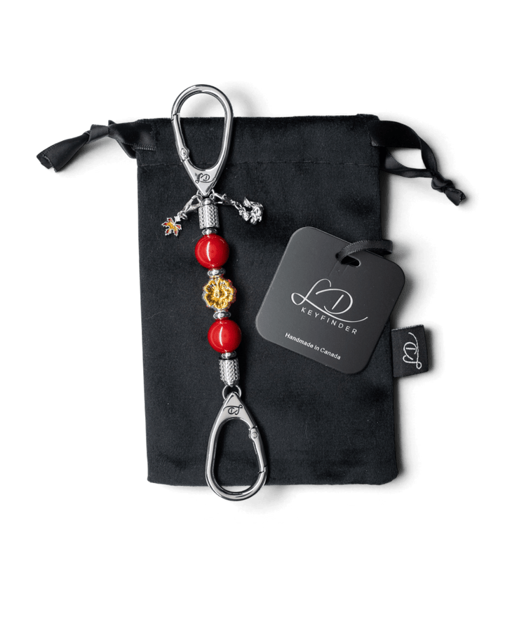 LD Keyfinder Autumn Whispers Mini featuring red shell pearls, orange glass flower, and platinum-plated charms.