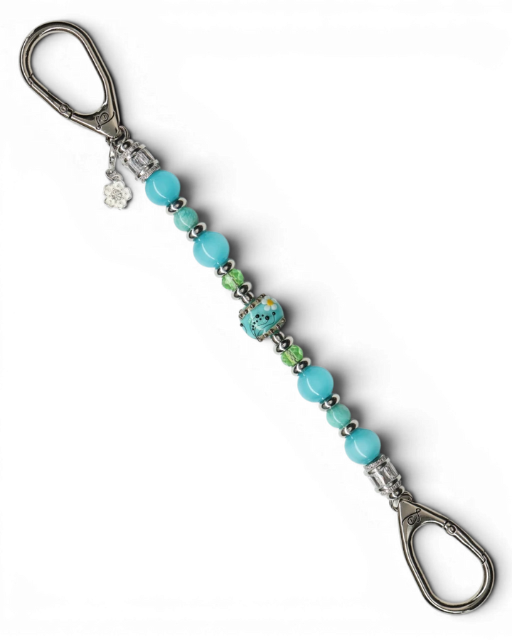 LD Keyfinder Azure Meadow keychain with aqua blue Amazonite, cat's eye beads, green glass beads, and a lampwork daisy bead.