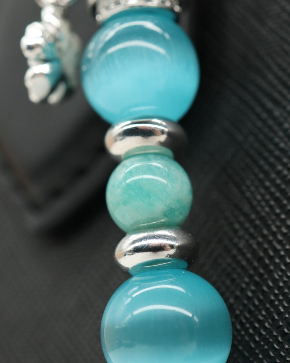 LD Keyfinder Azure Meadow bracelet with aqua blue cat's eye beads, Amazonite, and silver daisy charm.