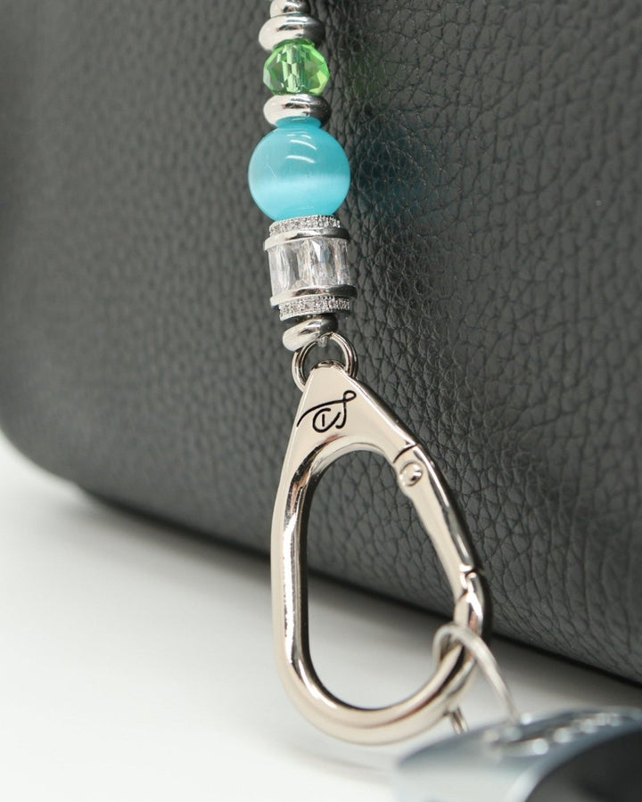 LD Keyfinder Petite Azure Meadow lanyard with aqua blue cat's eye beads, green glass beads, and a lampwork glass daisy bead.