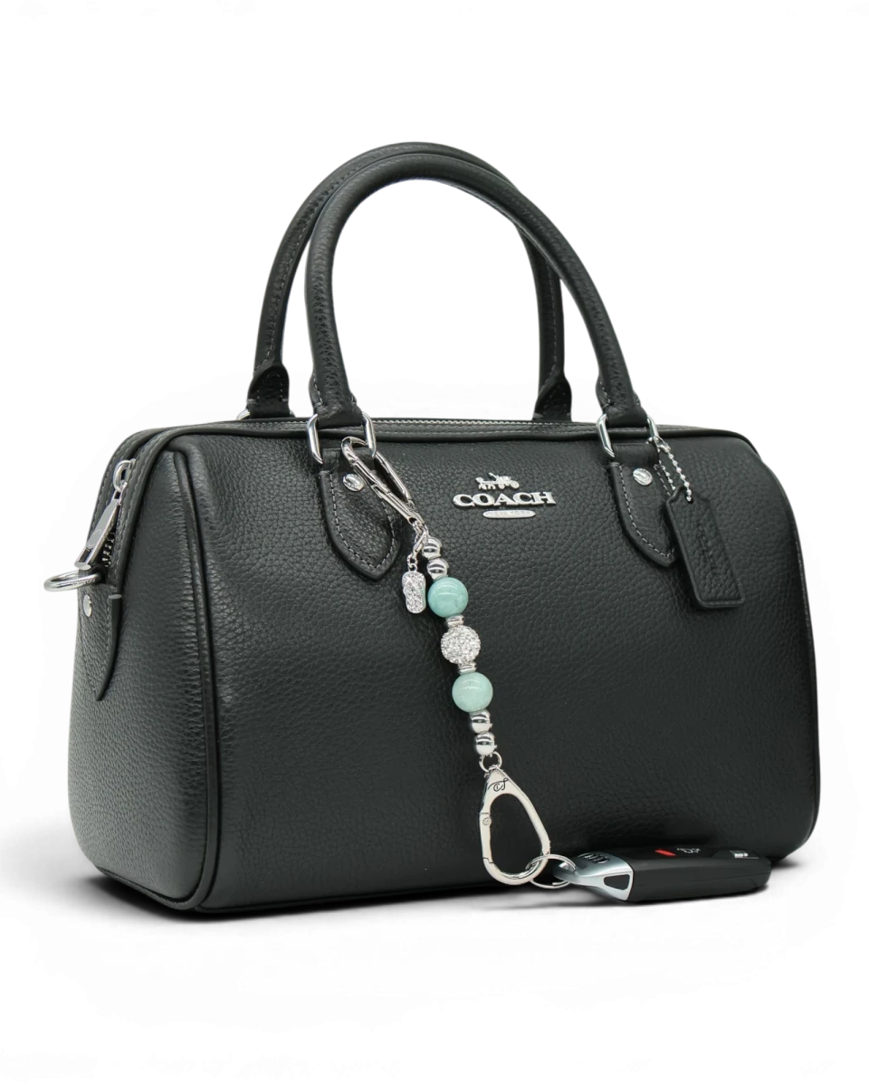 LD Keyfinder Beachside Bliss Mini beaded charm with aqua jade and crystal beads attached to a black leather handbag.