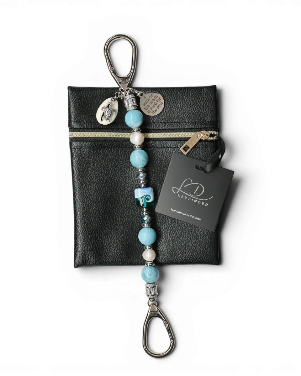 LD Keyfinder Beachy Dreams keychain with blue, teal, and white beads, freshwater pearls, a glass bead, turtle charm, and inspirational quote charm.