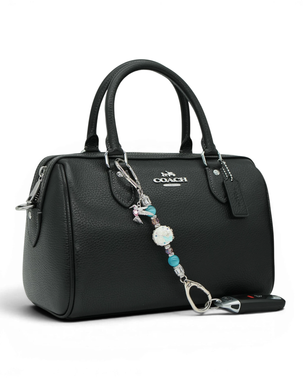LD Keyfinder Petite Garden Serenade accessory with aqua and pink beads and a hummingbird charm on a black handbag.