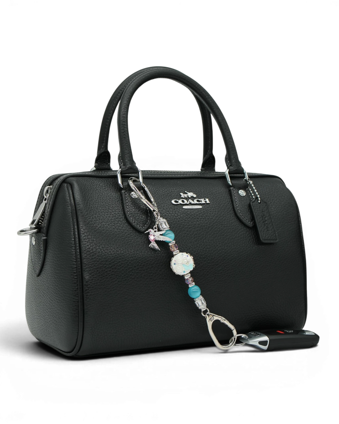 LD Keyfinder Petite Garden Serenade accessory with aqua and pink beads and a hummingbird charm on a black handbag.