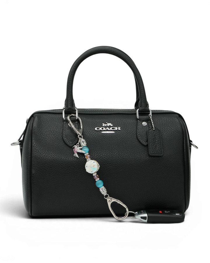 LD Keyfinder Petite Garden Serenade accessory with aqua and pink beads and hummingbird charm on a black handbag
