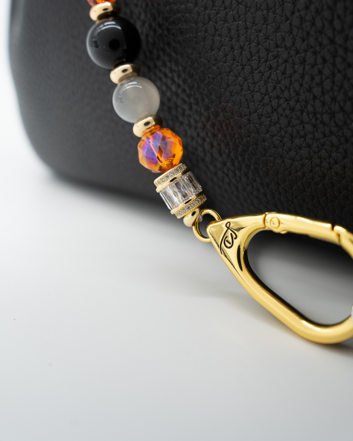 LD Keyfinder Bewitched Halloween accessory with black obsidian, moonstone, orange glass beads, and gold-plated clasp.