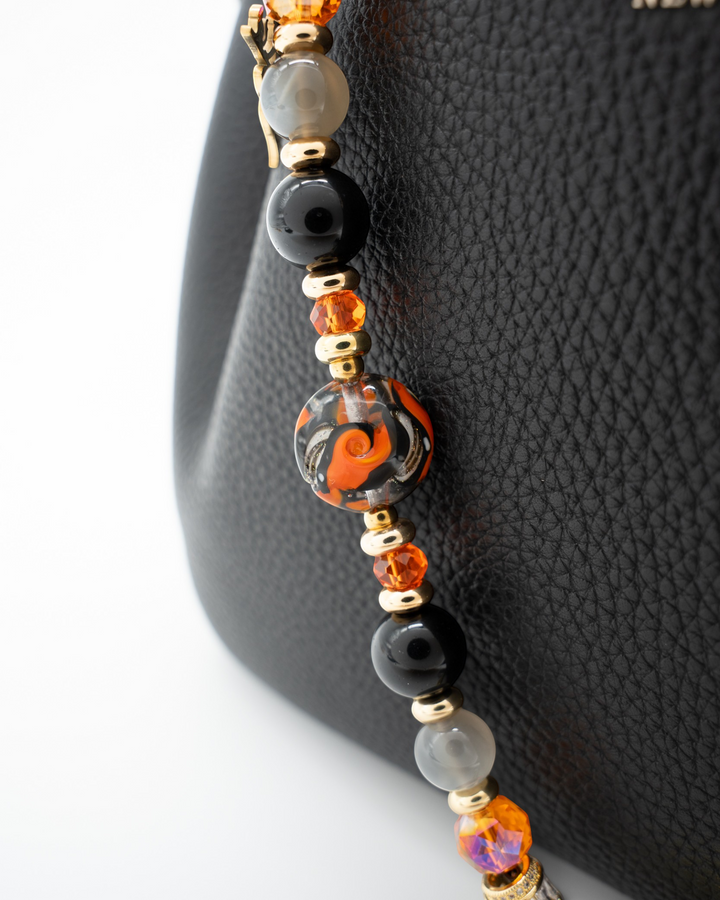 LD Keyfinder Bewitched Halloween beaded accessory with obsidian, moonstone, orange glass, and gold-plated witch charm.