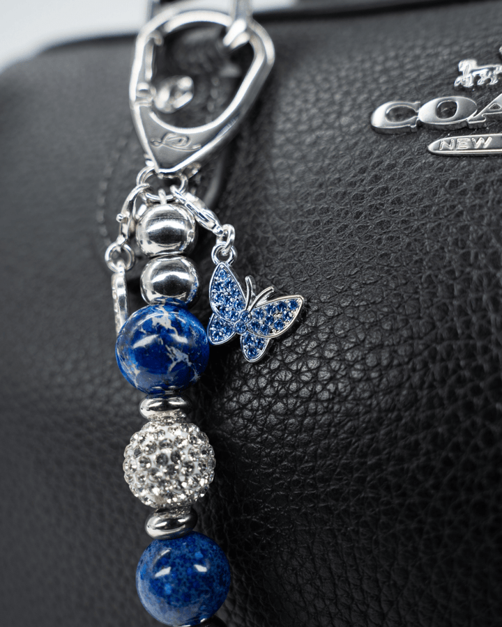 LD Keyfinder Blue Butterfly-Mini charm with blue pearlized beads, rhinestone spacers, and a silver butterfly pendant.