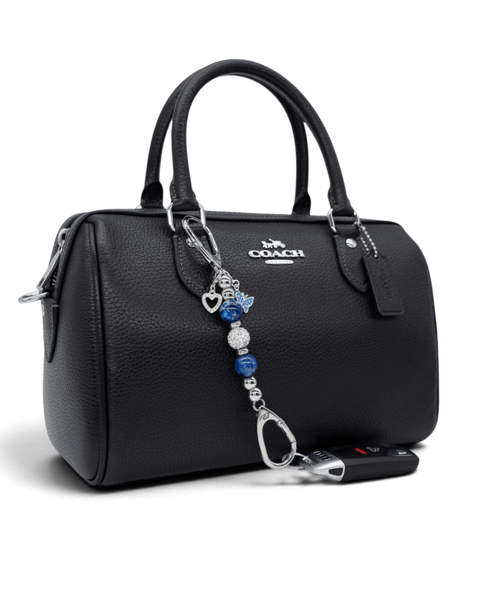LD Keyfinder Blue Butterfly-Mini beaded keychain with blue glass and silver charms attached to a black leather handbag