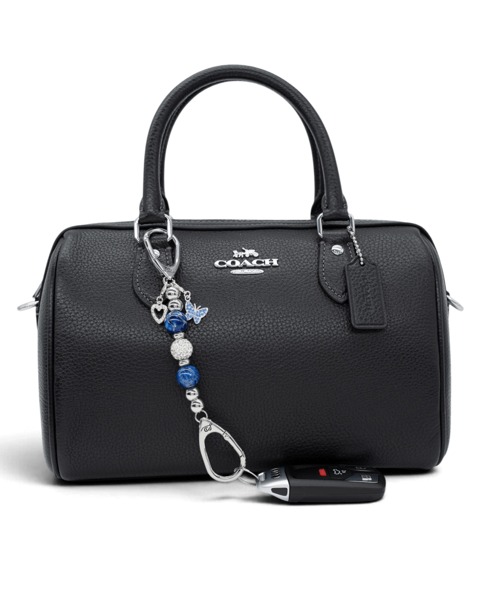 LD Keyfinder Blue Butterfly-Mini beaded keychain with blue glass beads and butterfly charm attached to a black handbag