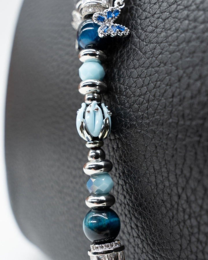 LD Keyfinder Petite Whispering Garden beaded accessory with a handcrafted blue glass tulip and gemstone accents.