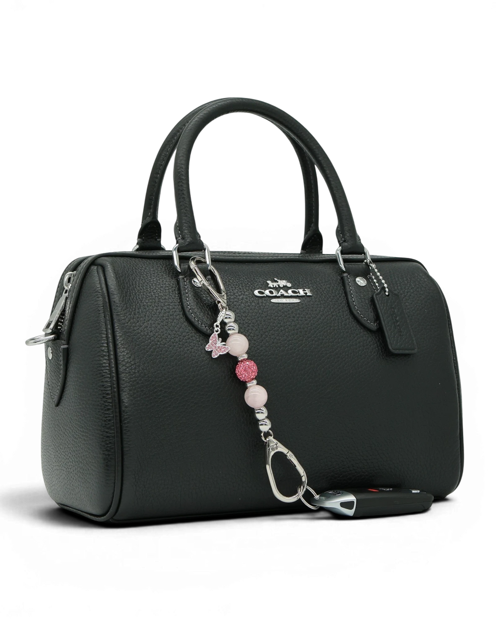 LD Keyfinder Blush Butterfly Mini charm with rose quartz beads and pink rhinestone butterfly on a black handbag.