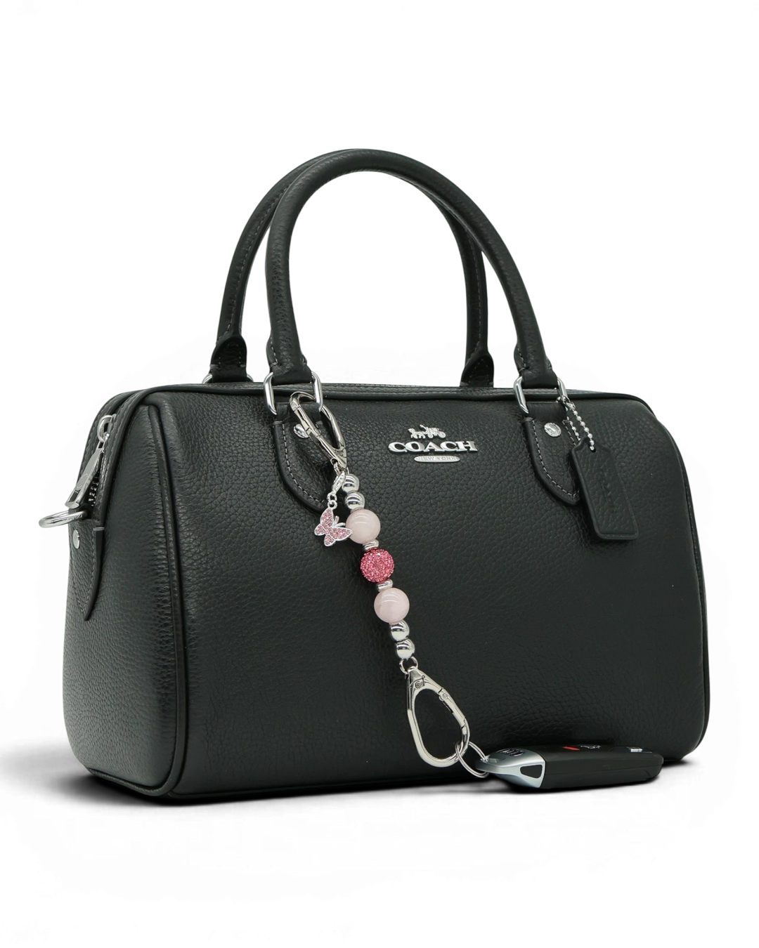 LD Keyfinder Blush Butterfly Mini charm with rose quartz beads and pink rhinestone butterfly on a black handbag.