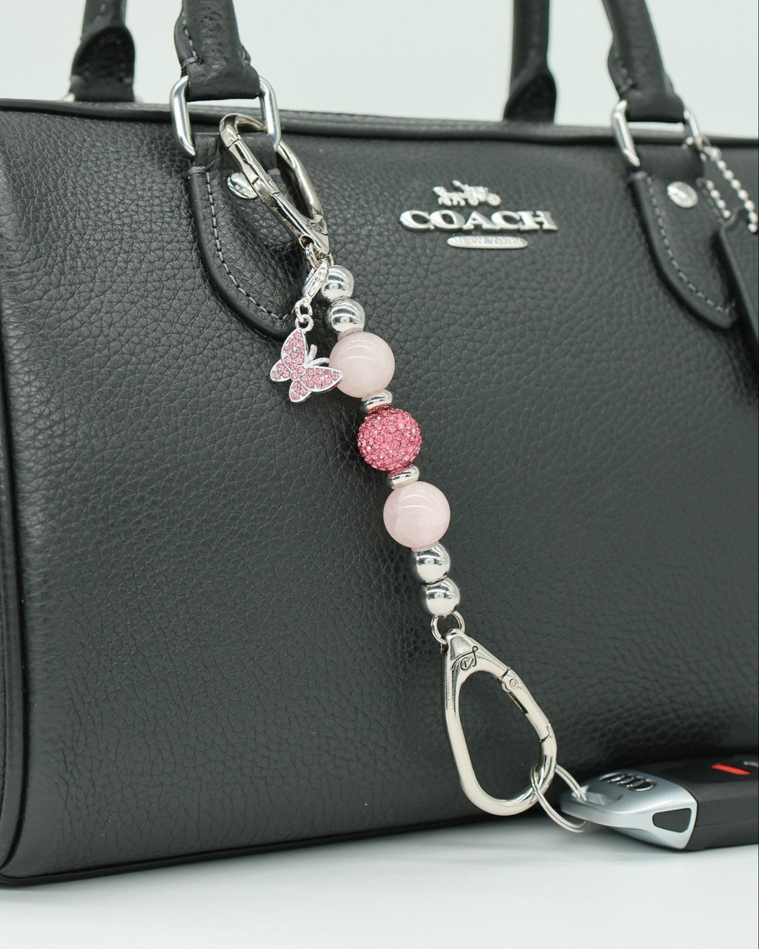LD Keyfinder Blush Butterfly Mini keychain with rose quartz, Austrian crystals, and pink rhinestone butterfly charm.