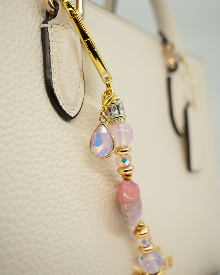 LD Keyfinder Blushing Opaline Petite featuring pink opalite beads, artisan glass, and gold-plated accents on a handbag.