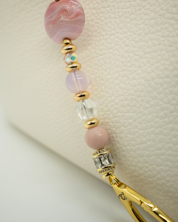 LD Keyfinder Blushing Opaline featuring pink opal beads, artisan glass, and 18KT gold-plated accents on a white bag.