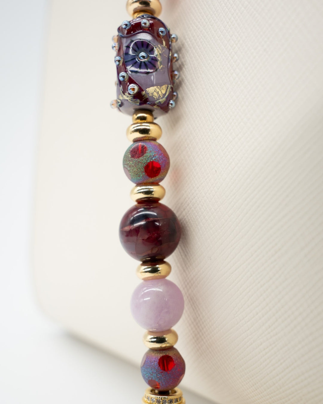 LD Keyfinder Bordeaux Bloom beaded accessory with artisan glass, burgundy agate, kunzite, and 18KT gold-plated accents.