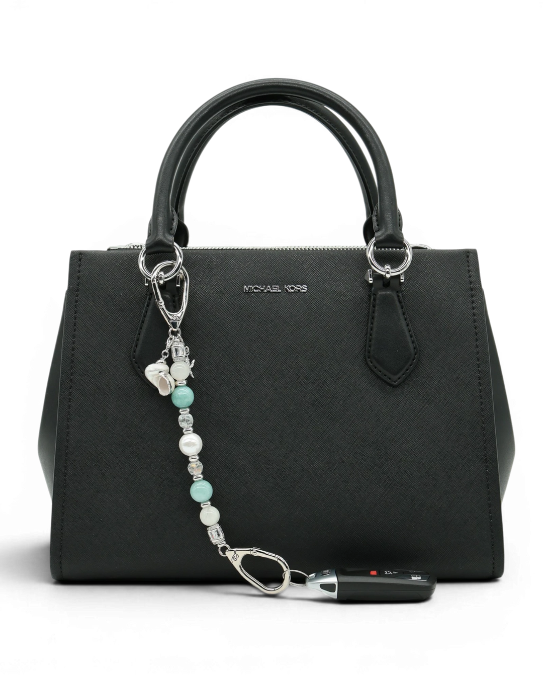 LD Keyfinder Caribbean Pearl beaded accessory featuring moonstone, aqua jade, and shell pearl attached to a black bag.