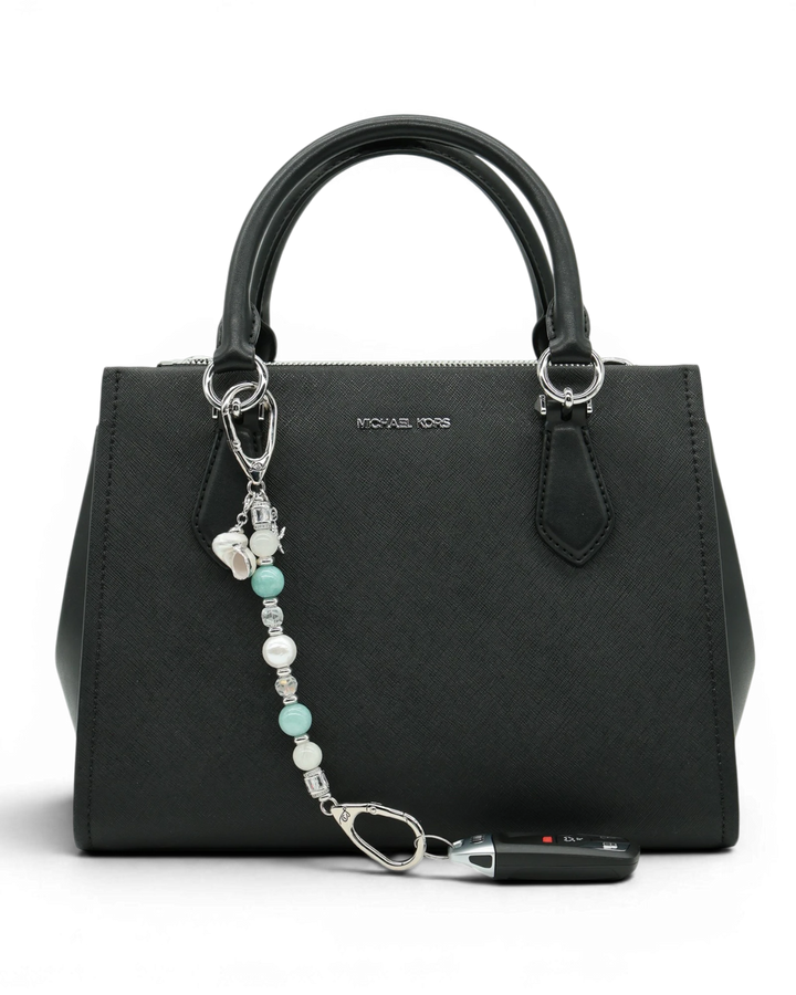 LD Keyfinder Caribbean Pearl beaded accessory featuring moonstone, aqua jade, and shell pearl attached to a black bag.