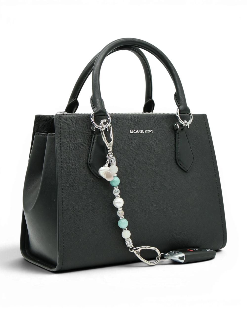 LD Keyfinder Caribbean Pearl beaded accessory featuring moonstone, aqua jade, and shell pearl attached to a black bag.