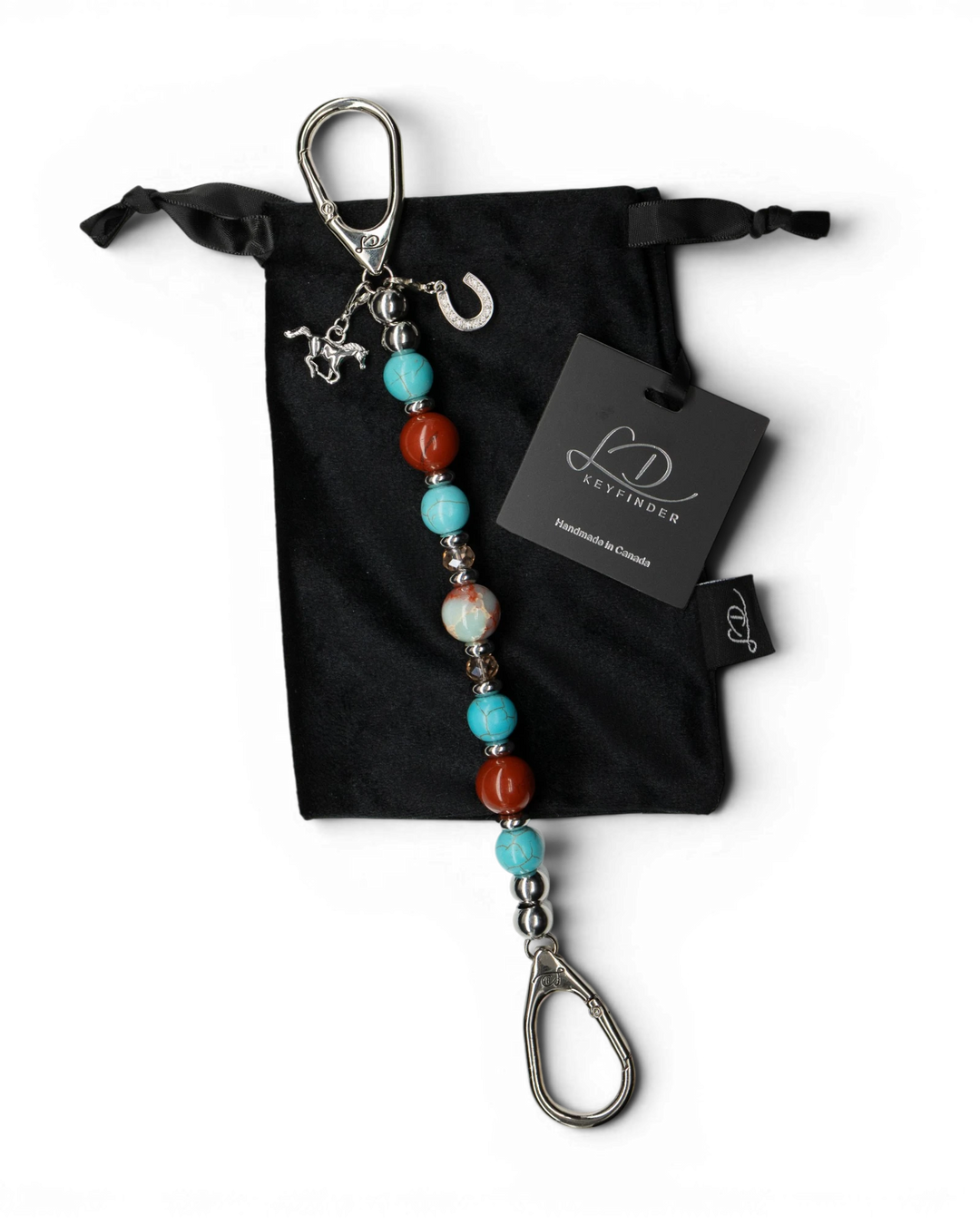 LD Keyfinder Cowgirl Dreams beaded keychain with jasper, turquoise, and horse charms on a black velvet pouch.