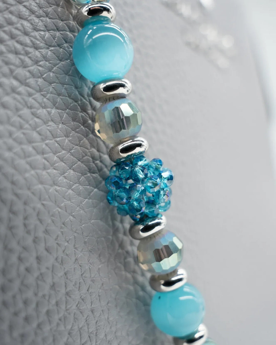 LD Keyfinder Dolphin Dream accessory featuring aqua cat's eye, etched glass, and faceted beads with platinum spacers.