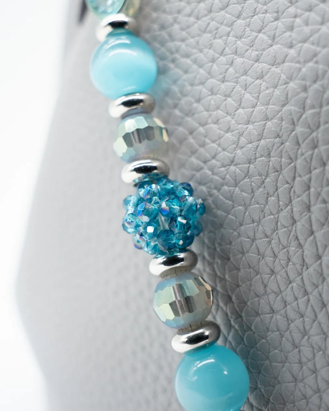 LD Keyfinder Dolphin Dream beaded accessory featuring aqua cat's eye, etched glass, and faceted beads with platinum spacers