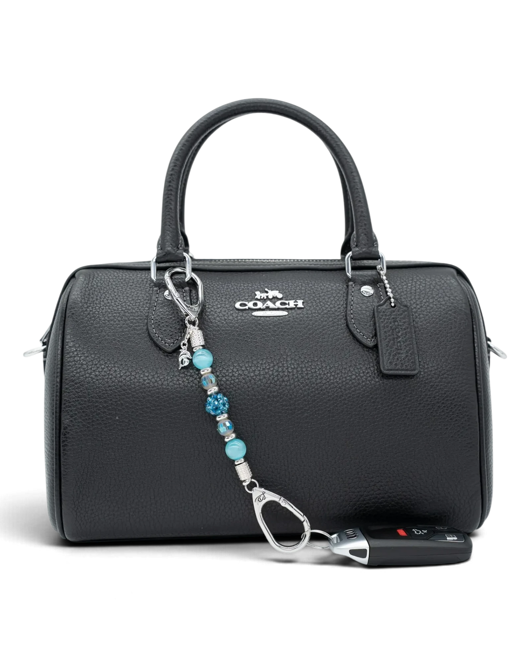 LD Keyfinder Dolphin Dream Mini featuring aqua beads and a rhinestone dolphin charm attached to a black leather bag.