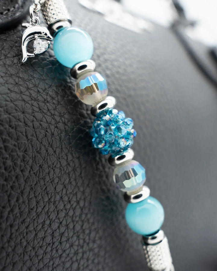 LD Keyfinder Dolphin Dream Mini featuring aqua beads, a woven glass centerpiece, and a rhinestone dolphin charm.
