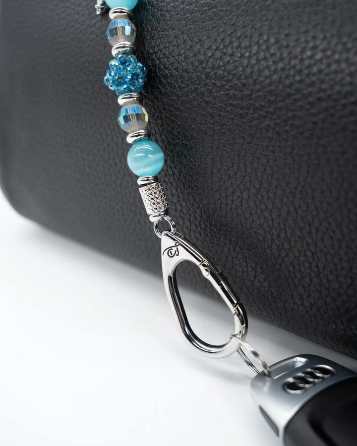 LD Keyfinder Dolphin Dream Mini featuring aqua cat's eye beads, faceted glass, and a rhinestone dolphin charm on a bag