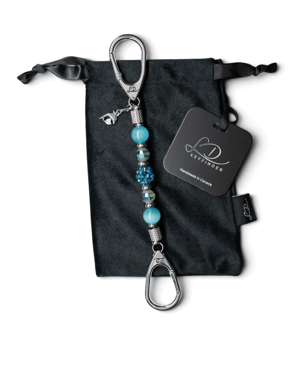 LD Keyfinder Dolphin Dream Mini beaded keychain with aqua glass beads and a rhinestone dolphin charm on a velvet bag