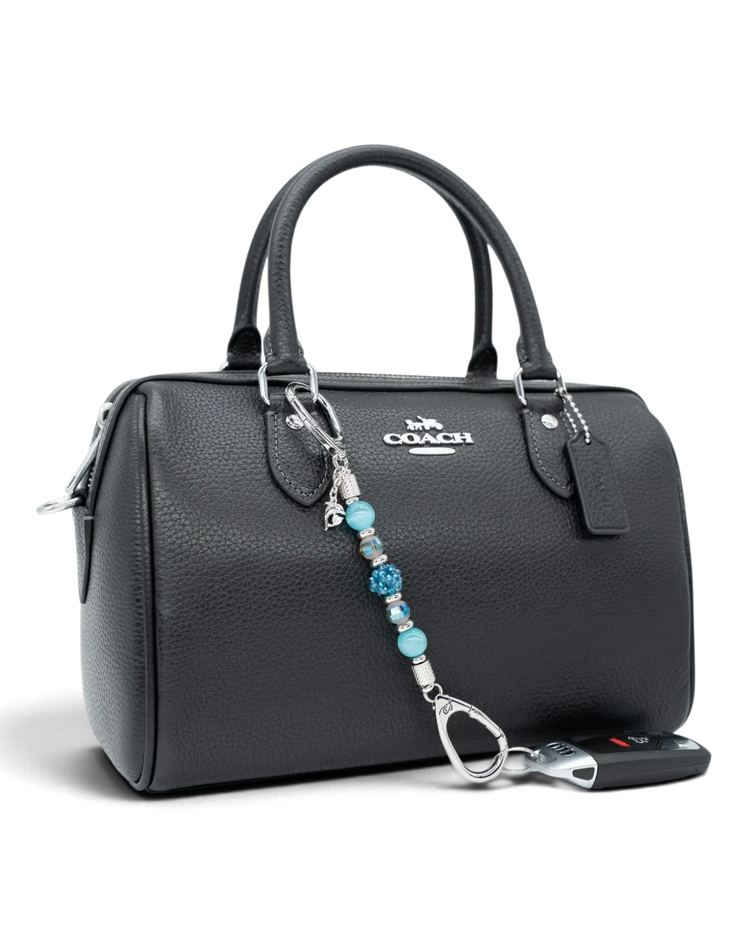 LD Keyfinder Dolphin Dream Mini beaded keychain with aqua glass beads and a rhinestone dolphin charm on a black bag.