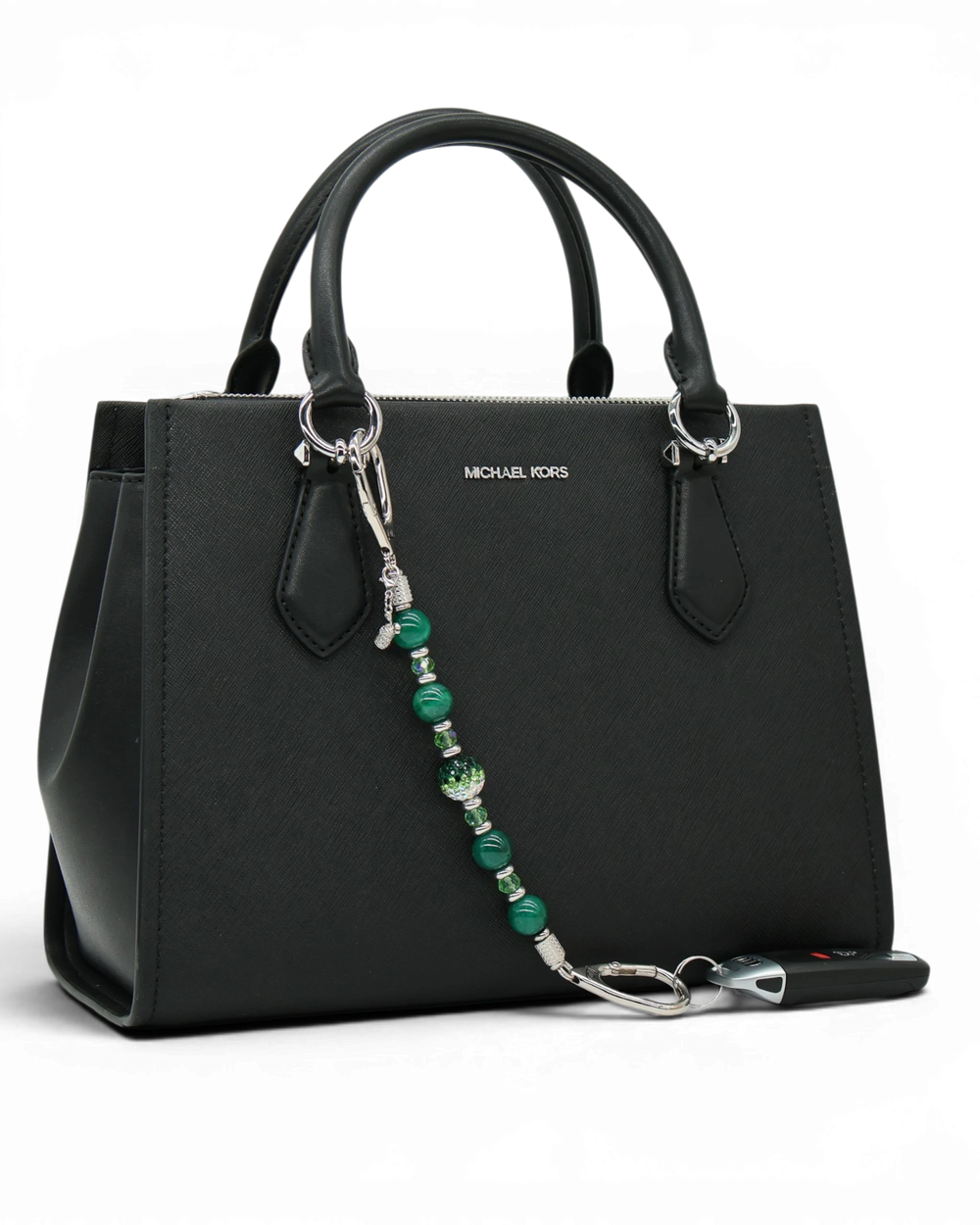 LD Keyfinder Emerald Links beaded keychain with green agate, Austrian crystals, and a golf bag charm on a black purse.