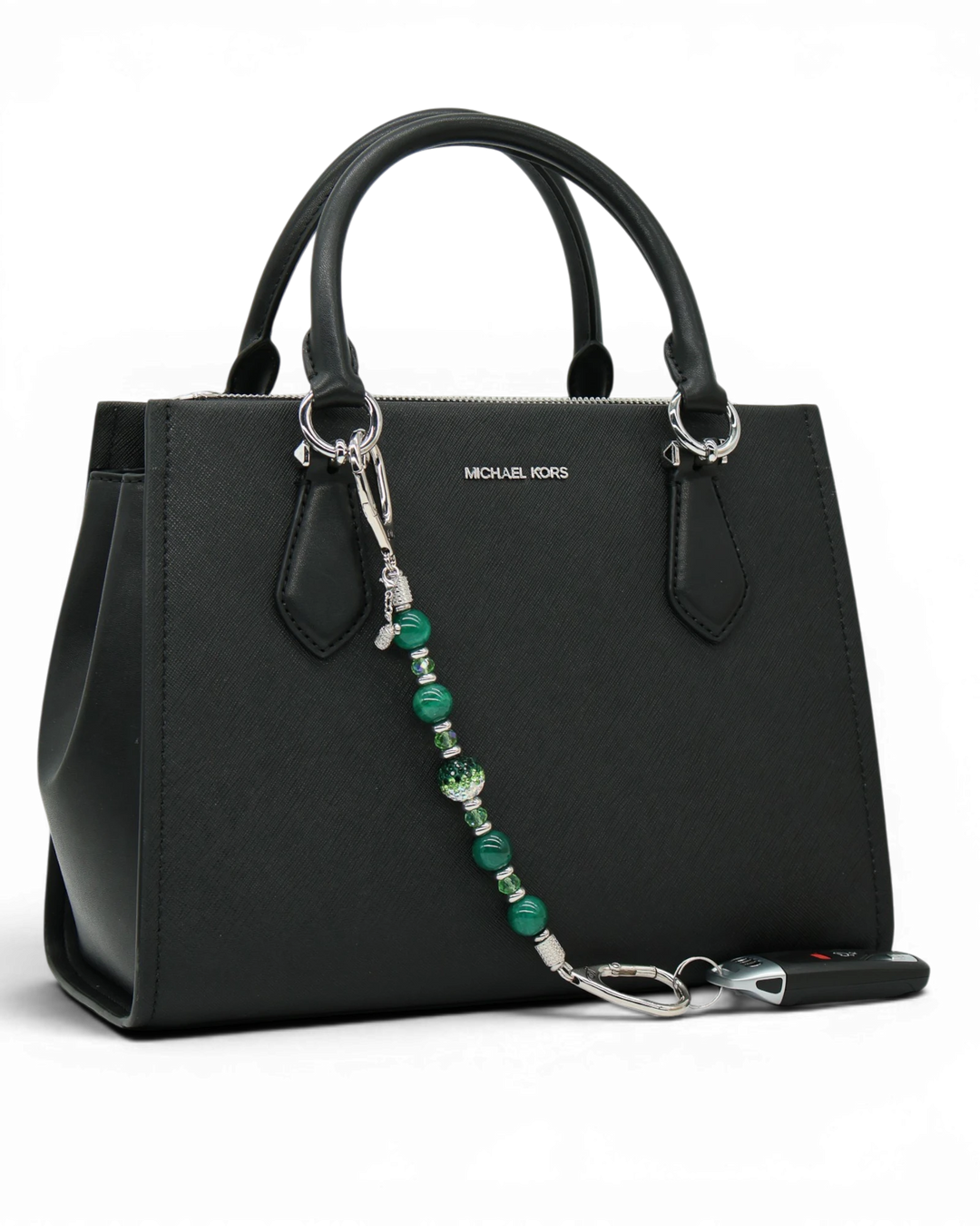 LD Keyfinder Emerald Links beaded keychain with green agate, Austrian crystals, and a golf bag charm on a black purse.