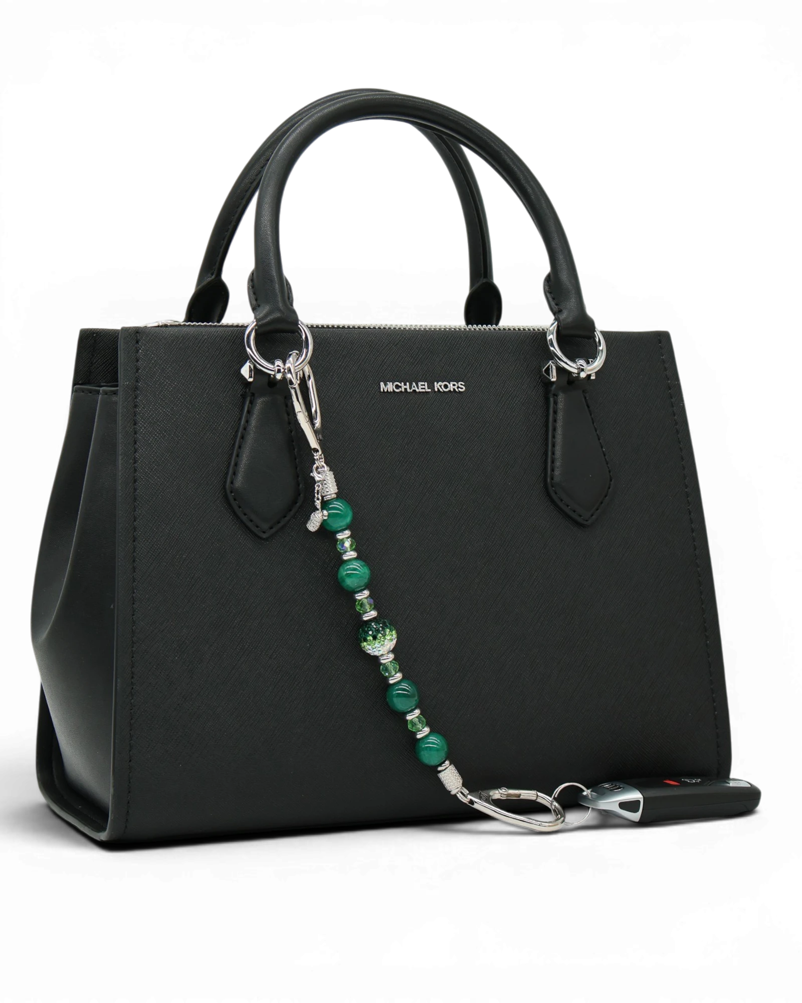 LD Keyfinder Emerald Links beaded keychain with green agate, Austrian crystals, and a golf bag charm on a black purse.