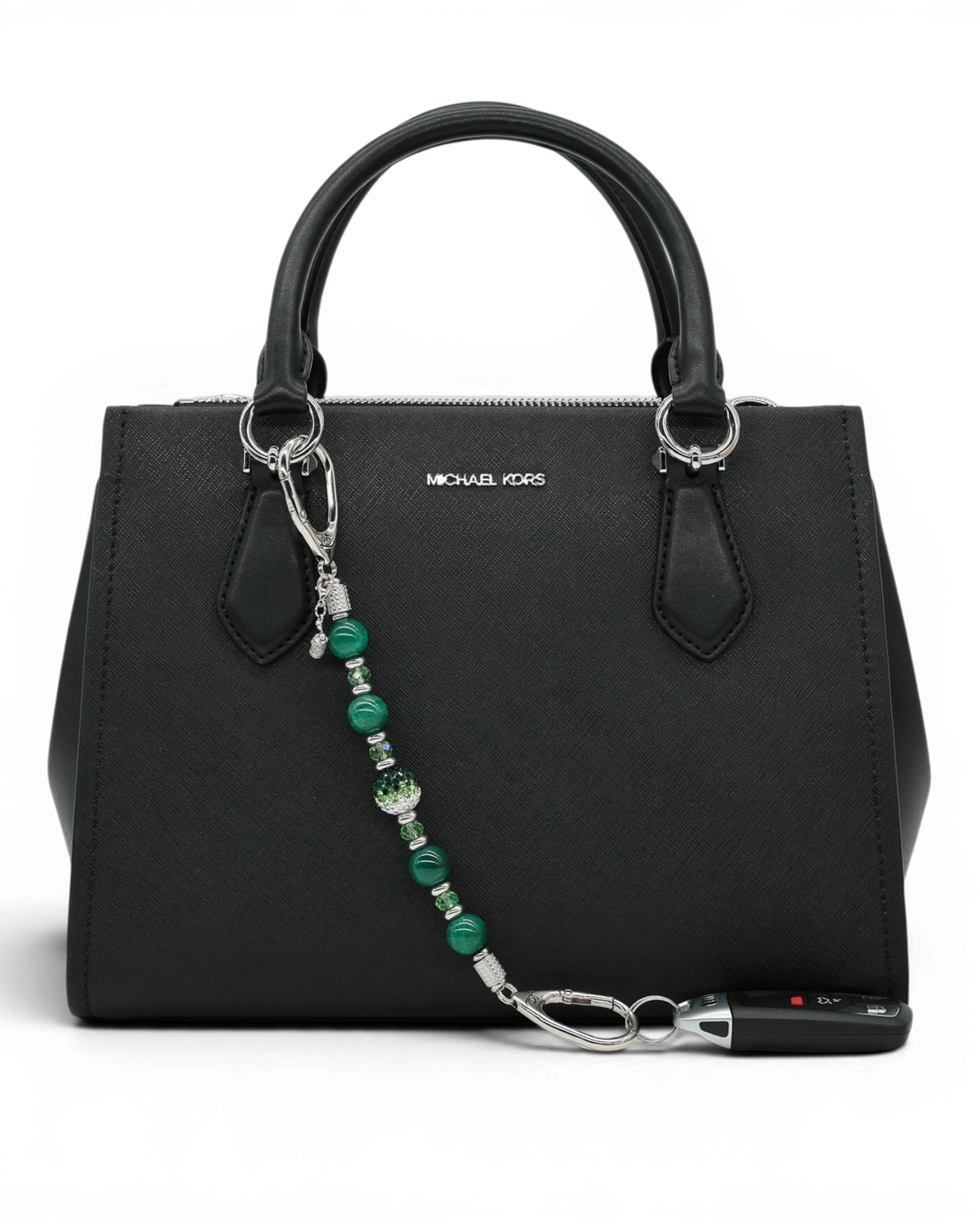 LD Keyfinder Emerald Links featuring green agate, glass beads, and a golf bag charm attached to a black handbag.