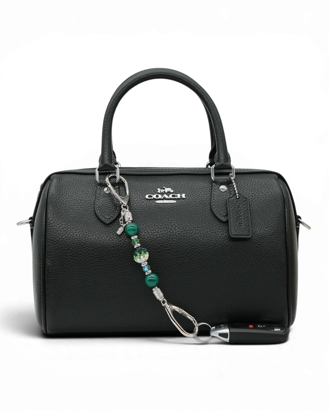 LD Keyfinder Emerald Links Mini with green beads and golf bag charm attached to a black leather handbag