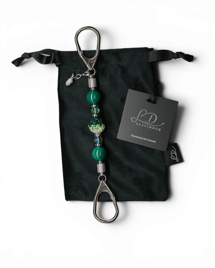 LD Keyfinder Emerald Links-Mini with green glass beads, Austrian crystal center, and golf bag charm on velvet pouch.