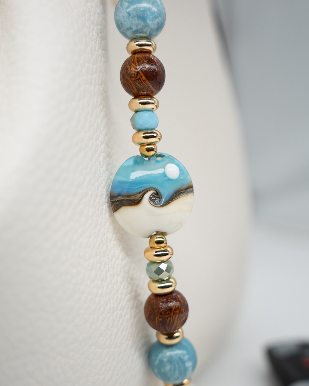LD Keyfinder Equinox Harmony beaded accessory featuring a handcrafted glass moon bead, moonstone, larimar, and jasper.