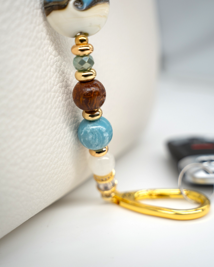 LD Keyfinder Equinox Harmony beaded accessory featuring artisan glass, moonstone, larimar, and gold-plated accents.