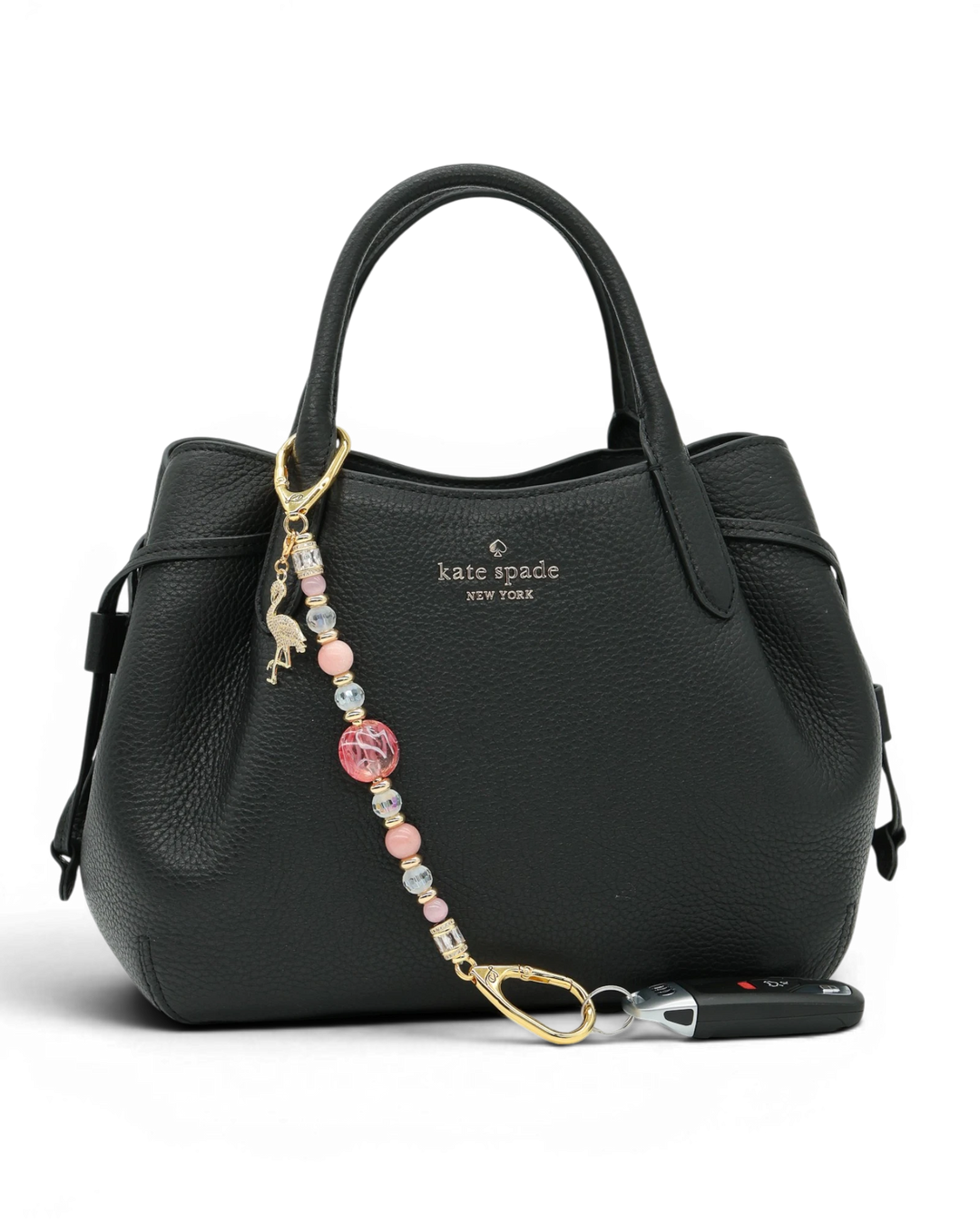 LD Keyfinder Flamingo Fantasy beaded accessory with pink opal and glass beads attached to a black leather handbag.