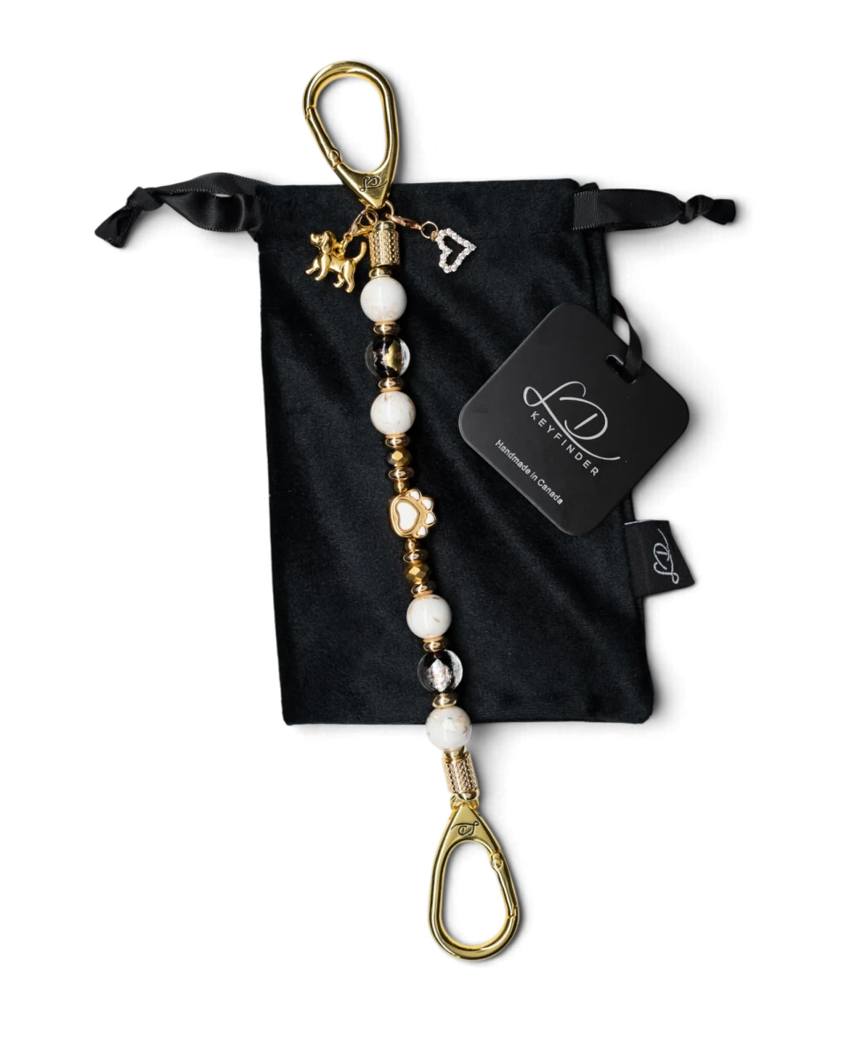 LD Keyfinder Furever Love beaded keychain with white seashell beads, gold paw charm, and heart pendant in velvet bag.
